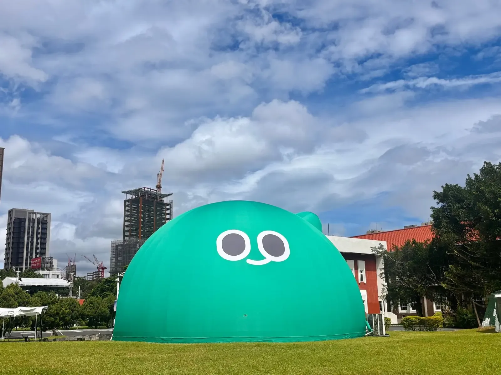 藍天白雲下，空總國家文化基地東草坪上的巨大綠色 a-We 實景